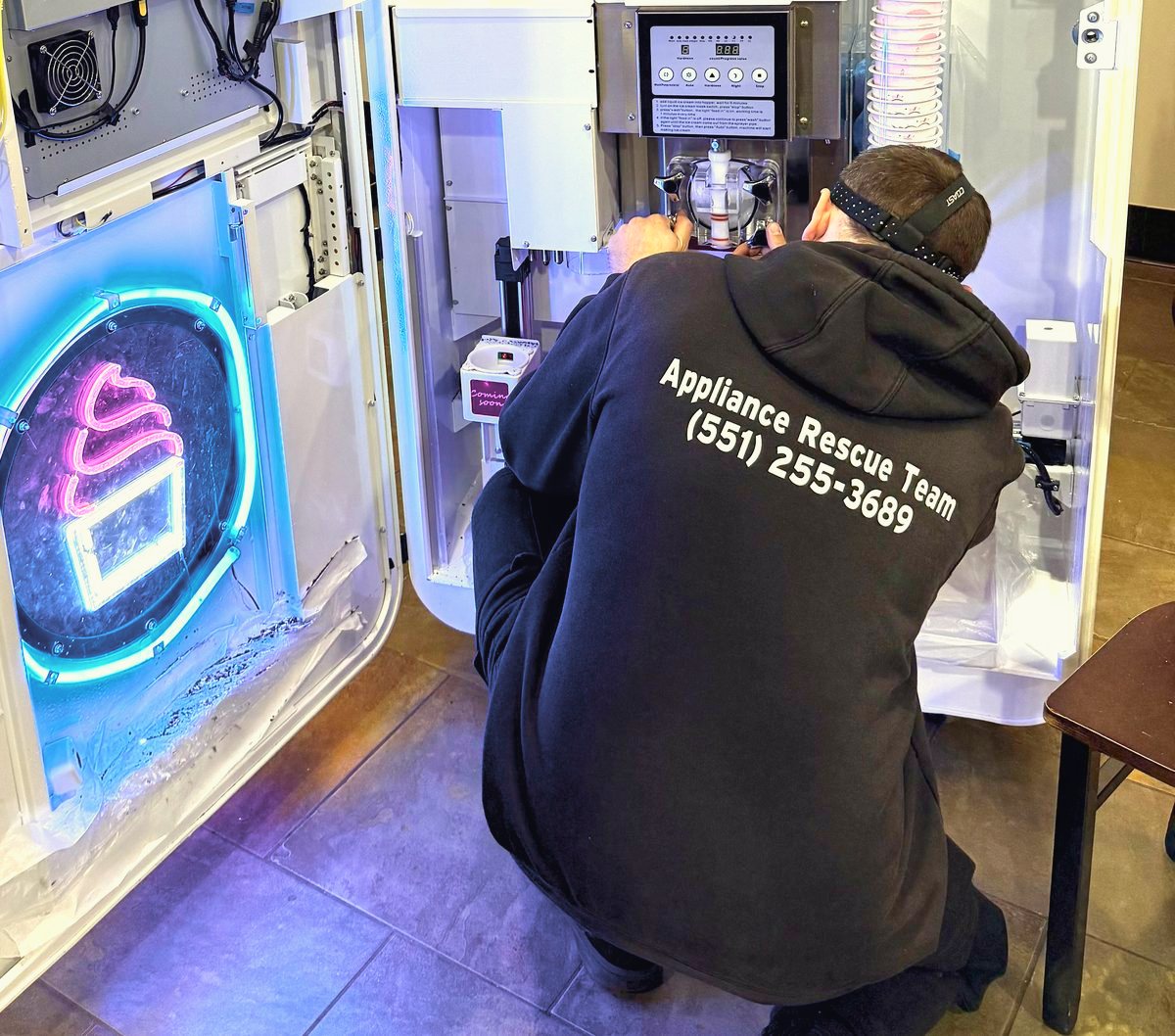 Appliance Rescue Team technician in branded uniform repairing a commercial appliance in Bergen County, NJ