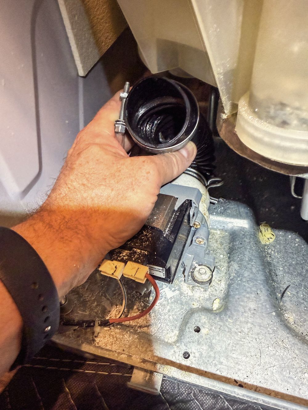 Appliance Rescue Team technician clearing and replacing a washer drain pump in Bergen County, NJ